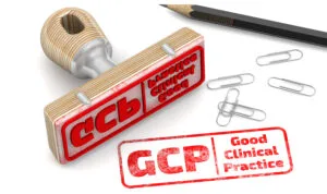 The stamp and red imprint GCP.Good Clinical Practice on a white surface.